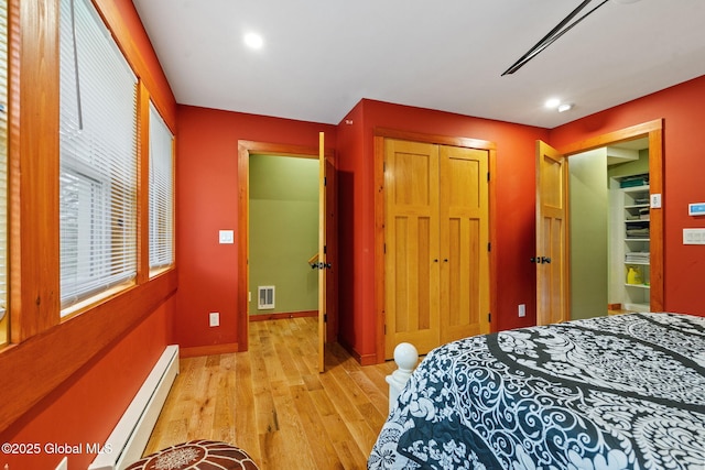 35 Scribner Hollow Rd # E3, Hunter, NY 12442 - bedroom with baseboard heating, light wood-style flooring, a closet, and recessed lighting