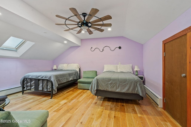 35 Scribner Hollow Rd # E3, Hunter, NY 12442 - bedroom featuring a baseboard radiator, vaulted ceiling, light wood-style floors, a skylight, and recessed lighting