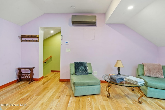 35 Scribner Hollow Rd # E3, Hunter, NY 12442 - sitting room with an AC wall unit, vaulted ceiling, wood finished floors, and an upstairs landing