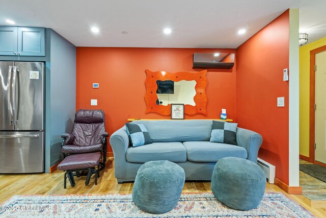 35 Scribner Hollow Rd # E3, Hunter, NY 12442 - living room featuring a wall mounted AC, light wood-style floors, recessed lighting, and a baseboard heating unit