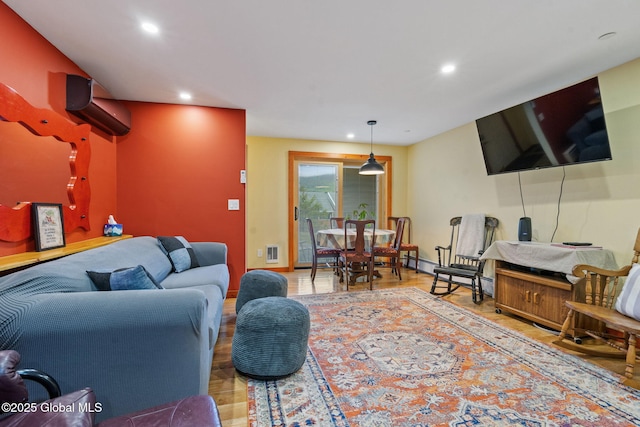 35 Scribner Hollow Rd # E3, Hunter, NY 12442 - living area featuring recessed lighting, a wall unit AC, wood finished floors, and baseboard heating