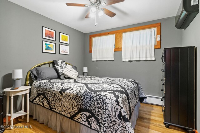 35 Scribner Hollow Rd # E3, Hunter, NY 12442 - bedroom featuring a baseboard radiator, wood finished floors, and a ceiling fan