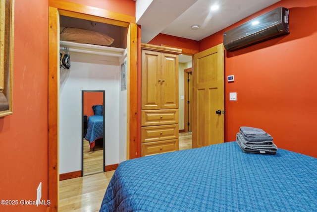 35 Scribner Hollow Rd # E3, Hunter, NY 12442 - bedroom with a wall unit AC, light wood-style floors, and a closet