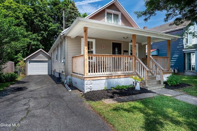 10 3rd St, South Glens Falls, NY 12803 - bungalow-style home with asphalt driveway, a porch, an outdoor structure, and a detached garage