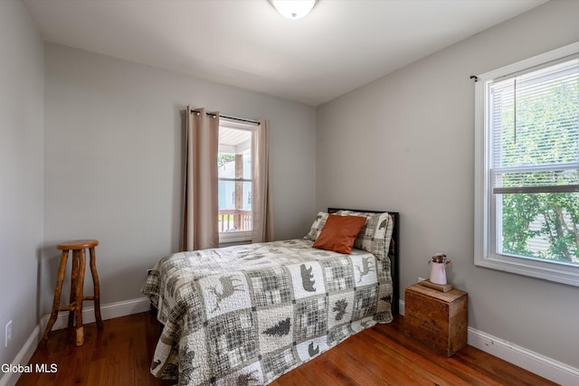 10 3rd St, South Glens Falls, NY 12803 - bedroom featuring multiple windows and wood finished floors