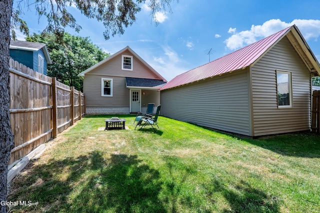 10 3rd St, South Glens Falls, NY 12803 - back of property with a metal roof and a fire pit