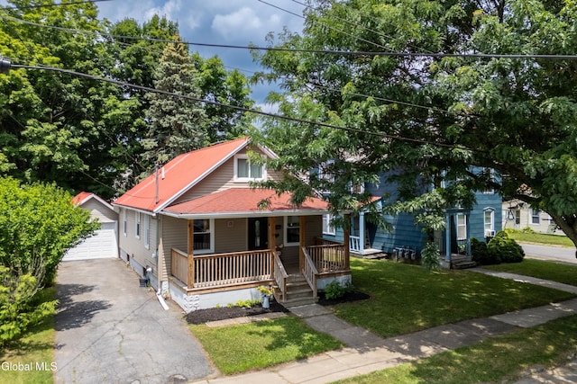 10 3rd St, South Glens Falls, NY 12803 - view of front of house featuring driveway, an outbuilding, a porch, a garage, and a front yard