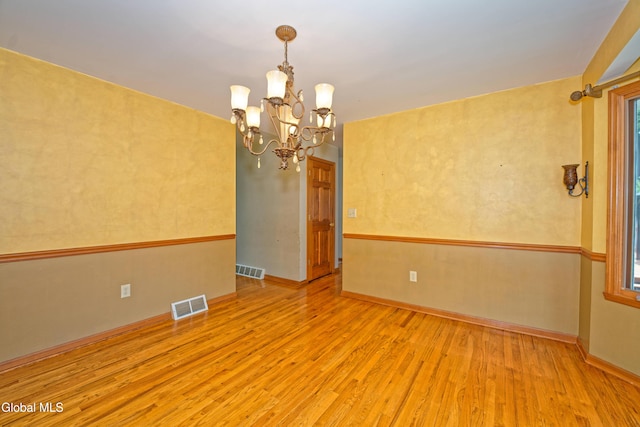 33 Cindy Ln, Halfmoon, NY 12065 - unfurnished room with wood finished floors, a chandelier, and plenty of natural light