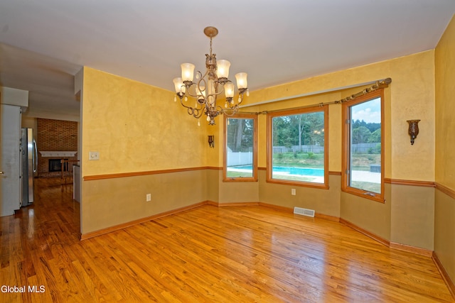 33 Cindy Ln, Halfmoon, NY 12065 - unfurnished room with wood finished floors and a chandelier