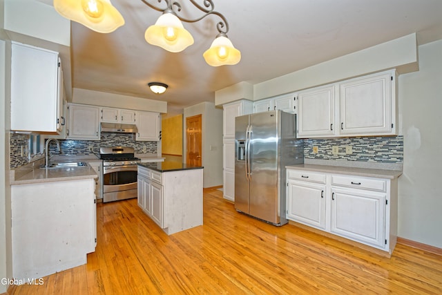 33 Cindy Ln, Halfmoon, NY 12065 - kitchen featuring stainless steel appliances, under cabinet range hood, tasteful backsplash, and white cabinetry