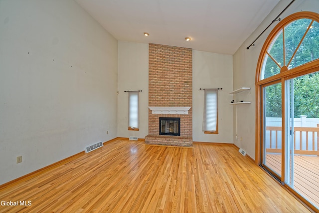 33 Cindy Ln, Halfmoon, NY 12065 - unfurnished living room featuring light wood-style flooring, high vaulted ceiling, and a fireplace