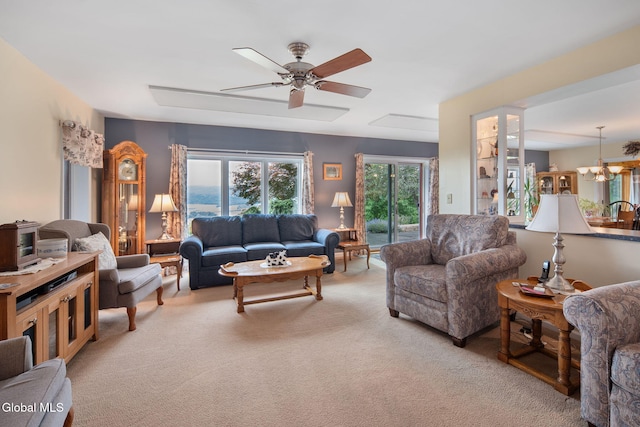 271 Settles Mountain Rd, Cobleskill, NY 12043 - living room featuring light colored carpet, a ceiling fan, and a chandelier