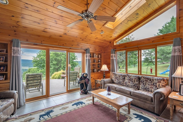 271 Settles Mountain Rd, Cobleskill, NY 12043 - tiled living area featuring plenty of natural light, wood ceiling, wood walls, ceiling fan, and a skylight
