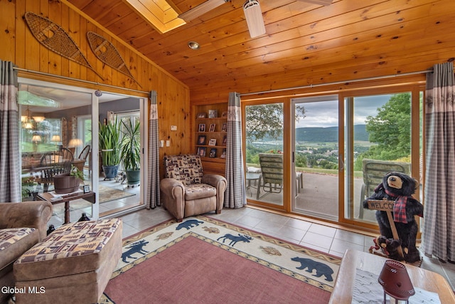 271 Settles Mountain Rd, Cobleskill, NY 12043 - tiled living area featuring lofted ceiling, wood walls, a skylight, and wood ceiling
