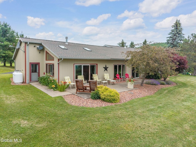 271 Settles Mountain Rd, Cobleskill, NY 12043 - rear view of house featuring a patio, a lawn, and roof with shingles
