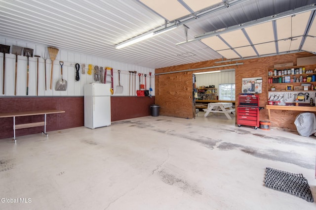 271 Settles Mountain Rd, Cobleskill, NY 12043 - garage featuring a workshop area and freestanding refrigerator