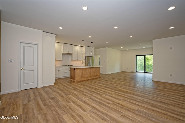 145C Bozenkill Rd, Altamont, NY 12009 - kitchen featuring open floor plan, appliances with stainless steel finishes, recessed lighting, a center island with sink, and light wood-style floors