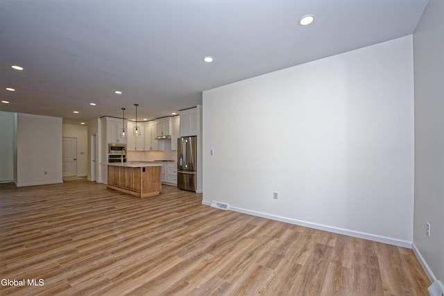 145C Bozenkill Rd, Altamont, NY 12009 - unfurnished living room with recessed lighting and light wood-style flooring