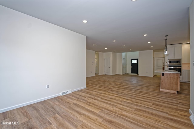 145C Bozenkill Rd, Altamont, NY 12009 - unfurnished living room with recessed lighting and light wood finished floors