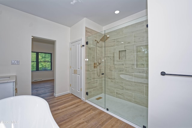 145C Bozenkill Rd, Altamont, NY 12009 - bathroom featuring a soaking tub, a shower stall, wood finished floors, and recessed lighting