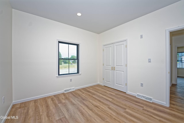 145C Bozenkill Rd, Altamont, NY 12009 - unfurnished bedroom with light wood-style floors, multiple windows, recessed lighting, and a closet