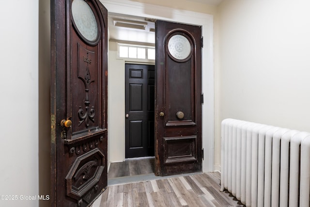 128 Circular St, Saratoga Springs, NY 12866 - foyer featuring radiator heating unit and light wood-style floors