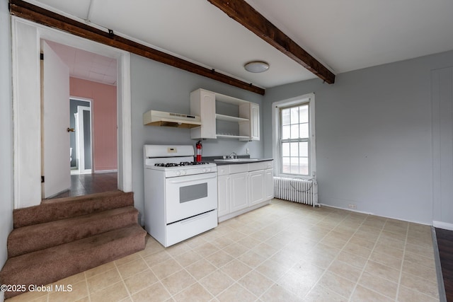 128 Circular St, Saratoga Springs, NY 12866 - kitchen with gas range gas stove, radiator, under cabinet range hood, white cabinets, and beamed ceiling
