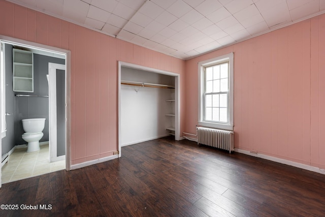 128 Circular St, Saratoga Springs, NY 12866 - unfurnished bedroom featuring radiator, hardwood / wood-style floors, a closet, and ensuite bathroom