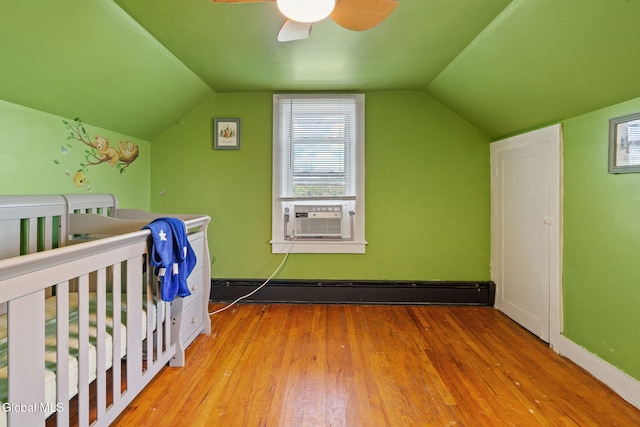 152 Charleston St, Esperance, NY 12066 - bedroom with cooling unit, a baseboard heating unit, hardwood / wood-style floors, vaulted ceiling, and a ceiling fan