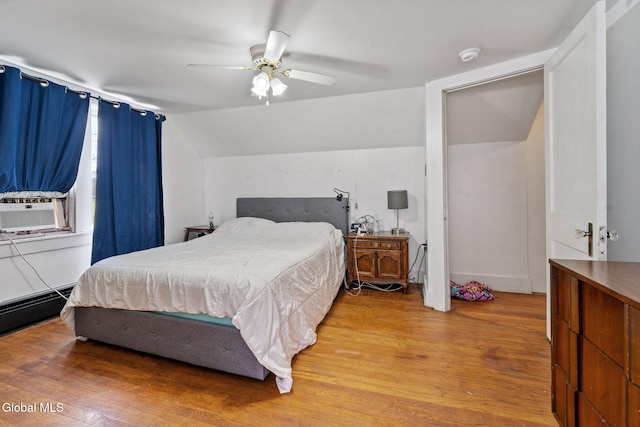 152 Charleston St, Esperance, NY 12066 - bedroom with wood finished floors, cooling unit, vaulted ceiling, a baseboard heating unit, and ceiling fan