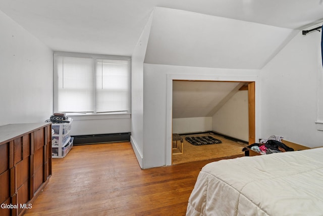 152 Charleston St, Esperance, NY 12066 - bedroom featuring baseboard heating, light wood-style flooring, and vaulted ceiling