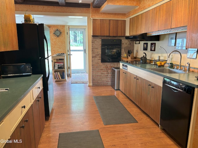 576 County Highway 102, Gloversville, NY 12078 - kitchen with black appliances, range hood, light wood-type flooring, dark countertops, and brown cabinets