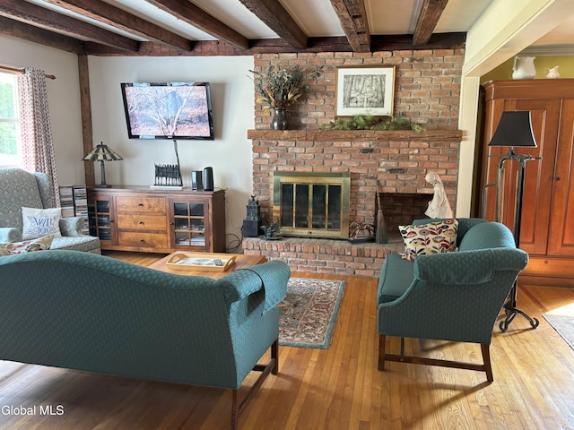 576 County Highway 102, Gloversville, NY 12078 - living area with beamed ceiling, hardwood / wood-style floors, and a brick fireplace