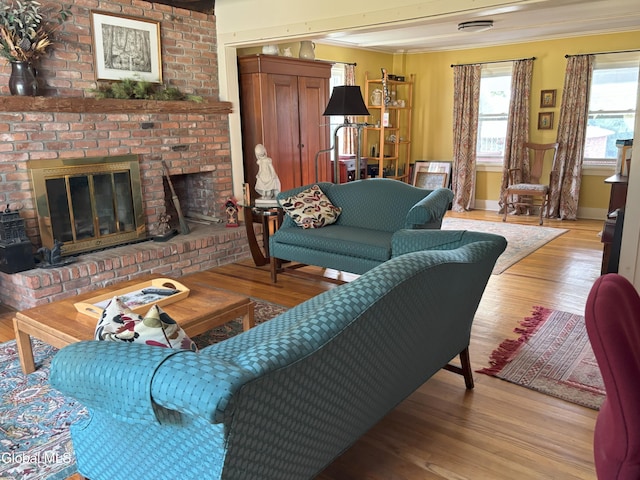 576 County Highway 102, Gloversville, NY 12078 - living area with crown molding, light wood-style floors, and a fireplace