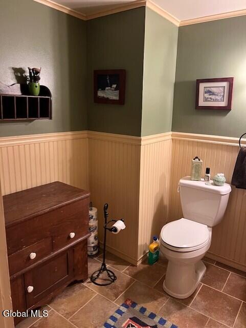 576 County Highway 102, Gloversville, NY 12078 - half bathroom featuring wainscoting, crown molding, and tile patterned floors