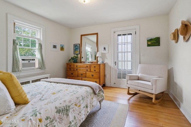 1556 Wendell Ave, Schenectady, NY 12308 - bedroom featuring light wood-type flooring, radiator heating unit, and cooling unit