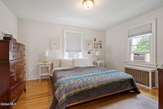 1556 Wendell Ave, Schenectady, NY 12308 - bedroom with multiple windows, radiator, light wood-style flooring, and cooling unit