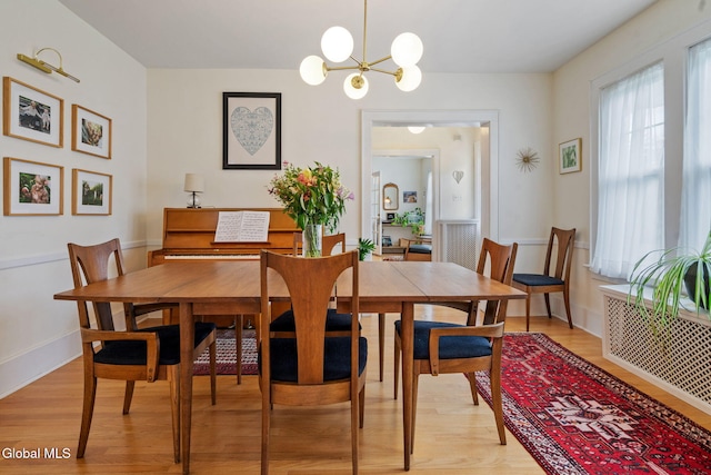 1556 Wendell Ave, Schenectady, NY 12308 - dining room with light wood finished floors, plenty of natural light, a chandelier, and radiator