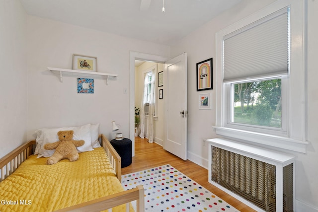 1556 Wendell Ave, Schenectady, NY 12308 - bedroom with radiator heating unit, multiple windows, and light wood finished floors