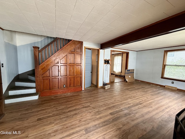 74 Park St, Gloversville, NY 12078 - unfurnished living room with stairway and wood finished floors