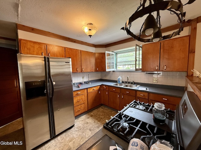 74 Park St, Gloversville, NY 12078 - kitchen with stainless steel fridge with ice dispenser, stove, brown cabinetry, dark countertops, and a textured ceiling