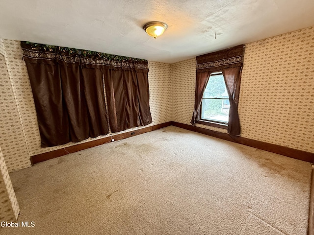 74 Park St, Gloversville, NY 12078 - empty room featuring wallpapered walls and light carpet