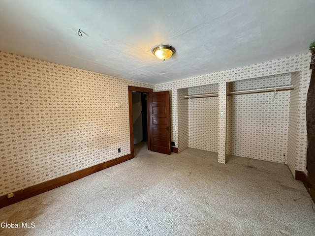 74 Park St, Gloversville, NY 12078 - unfurnished bedroom featuring wallpapered walls and carpet floors