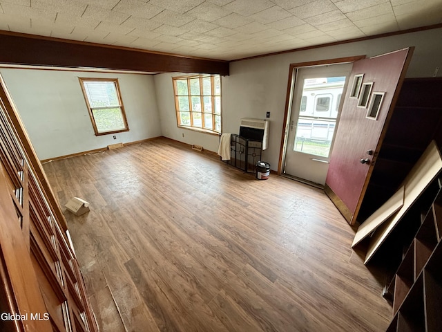 74 Park St, Gloversville, NY 12078 - unfurnished living room with wood finished floors, heating unit, and ornamental molding