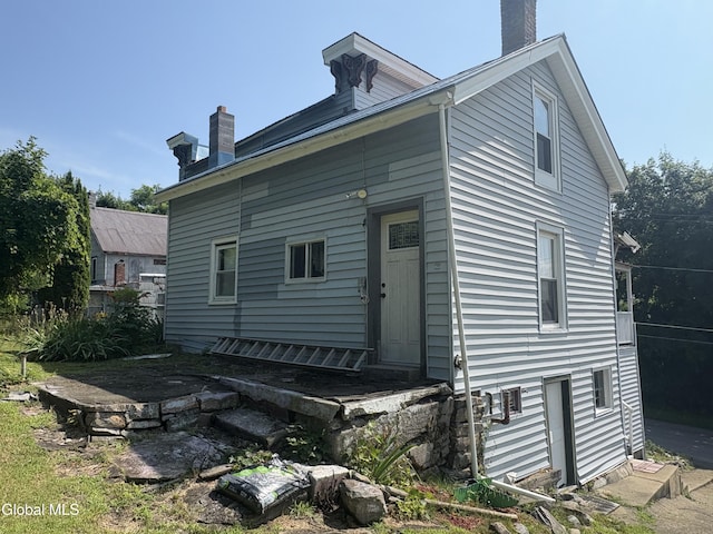 5 Spring St, Port Henry, NY 12974 - rear view of property featuring a chimney