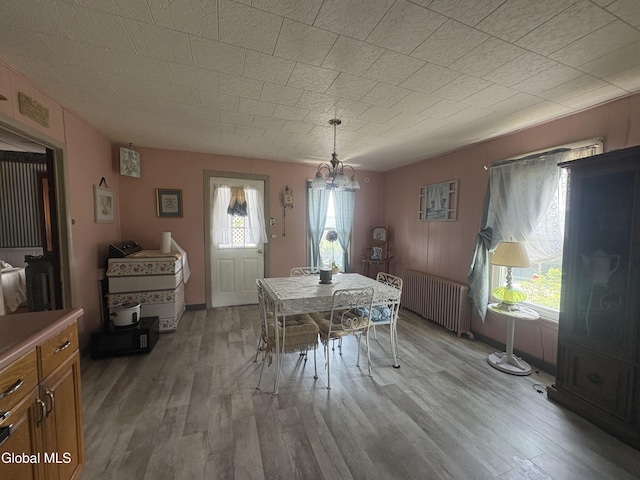 5 Spring St, Port Henry, NY 12974 - dining area with radiator, wood finished floors, and a chandelier