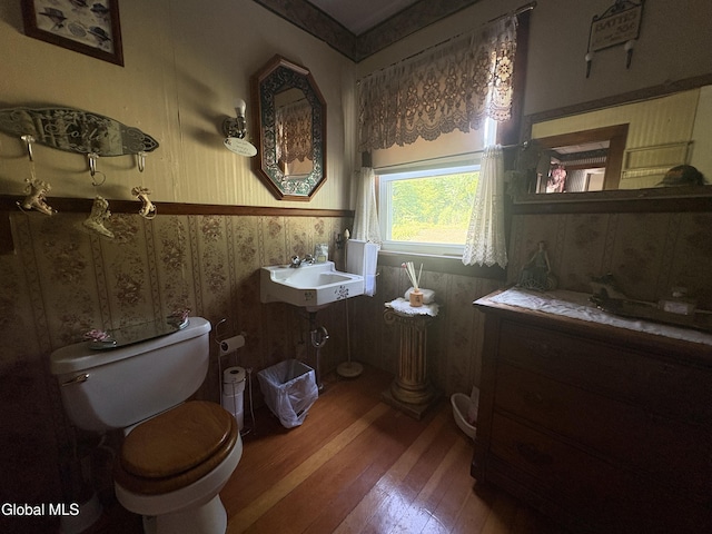 5 Spring St, Port Henry, NY 12974 - half bath with wood-type flooring, wainscoting, and wallpapered walls