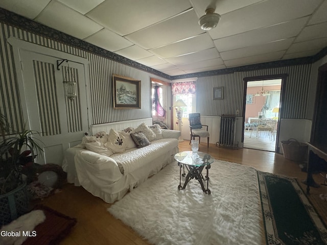 5 Spring St, Port Henry, NY 12974 - living area featuring wood finished floors, radiator, and wallpapered walls