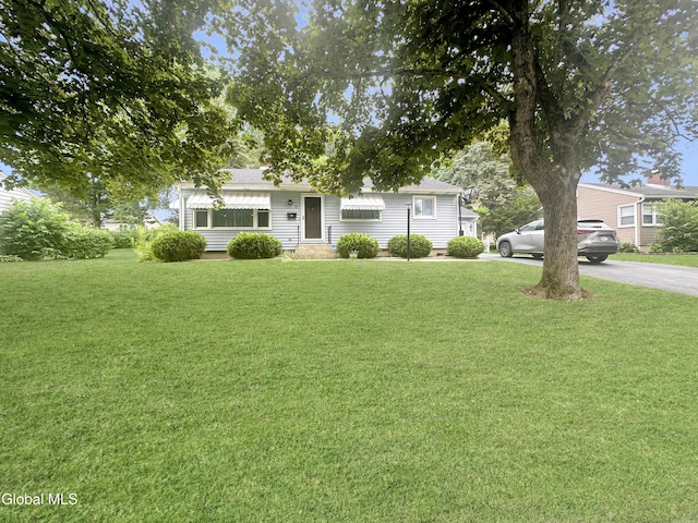 32 Abeling St, Canajoharie, NY 13317 - view of front facade with a front yard, a shingled roof, and entry steps