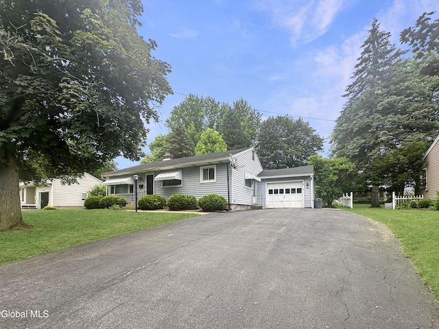 32 Abeling St, Canajoharie, NY 13317 - ranch-style home with driveway, a front lawn, a chimney, an attached garage, and a shingled roof